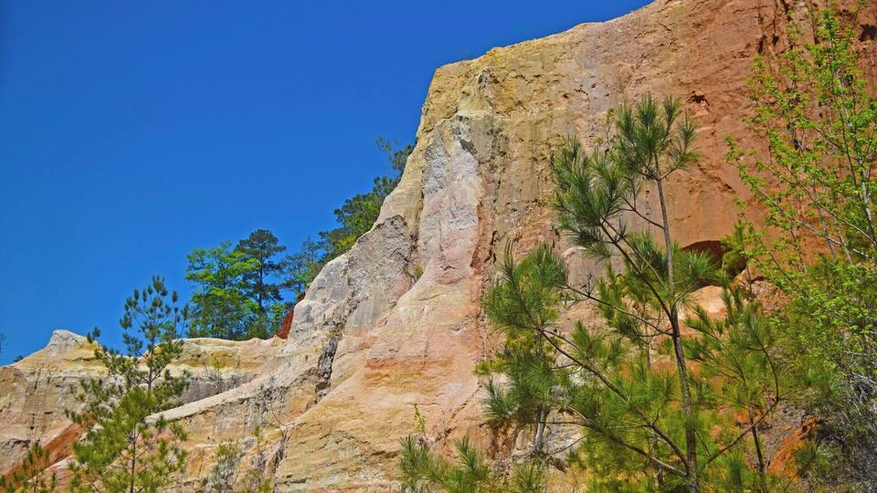 A rocky cliff with a clear blue sky.