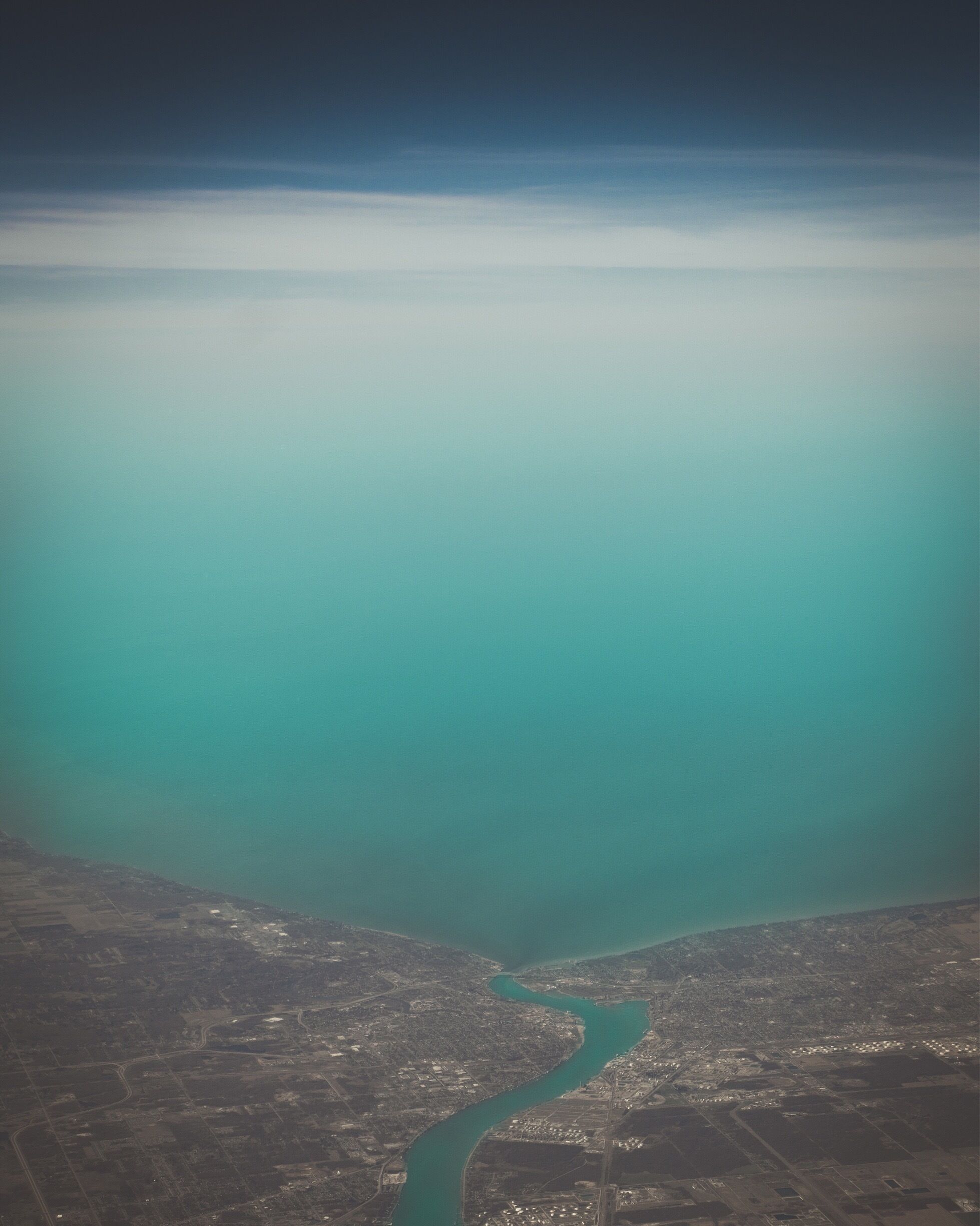 While flying to Toronto Canada, you cross the US/Canada border right over Port Huron Michigan and the river divides the two countries. Pretty beautiful scene to take in from about 30,000 feet above it all!

#aboveitall 
#flying #bvssquad #usa #canada
#blue
