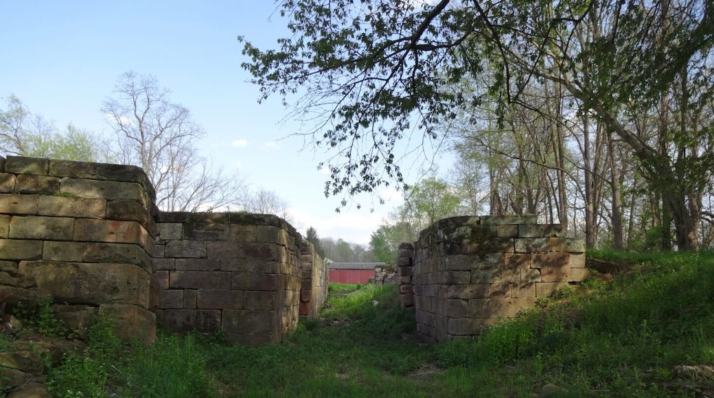 Lockville Canal Park is a 7 acre green space that contains three intact locks that once made up part of the central section of the Ohio and Erie Canal, a 308-mile highway of water that connected Lake Erie at Cleveland to the Ohio River at Portsmouth.
Construction on the locks began on July 4th, 1825 and took over seven years to complete. The canal system propelled Ohio's economy from last in the nation to nearly first in just a few years.
Seen in the background is Hartman Number 2 Covered Bridge, a late nineteenth-century covered bridge featuring a queenpost truss, shake roofing and red plank siding.
