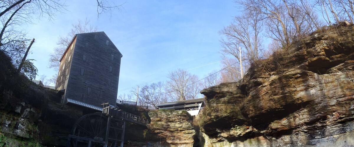 Rock Mill Park encompasses the historic Rock Mill, a stunning grist mill built in 1824 above the Hocking River Falls and the scenic Rock Mill Covered Bridge, constructed in 1901.
Standing 90 feet above the gorge of the falls, Rock Mill was one of a dozen mills in the area whose power source was the Hocking River. The mill was in operation grinding flour and corn into wheat and meal as late at 1905.