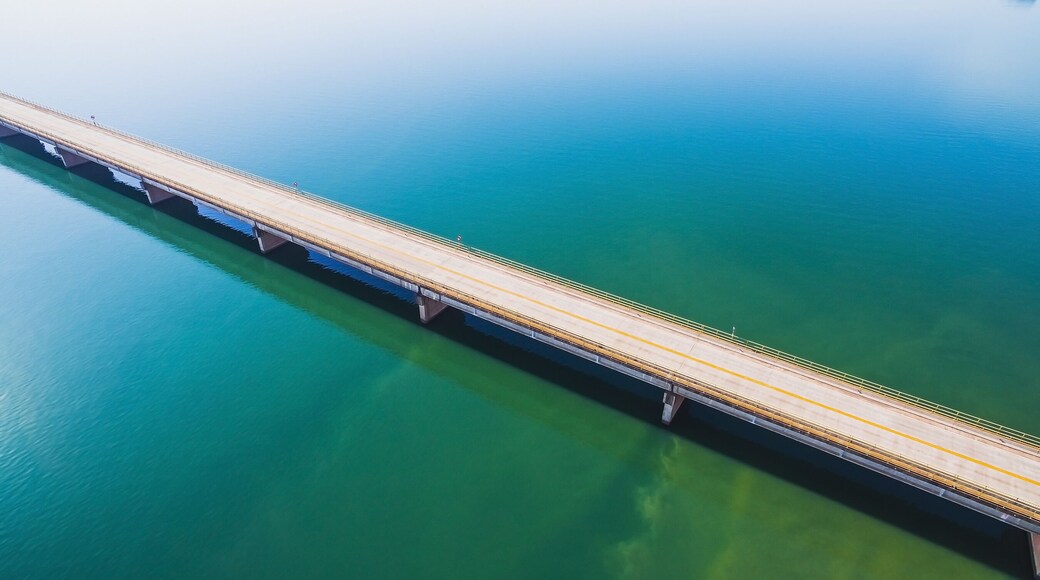 Aerial view of a long highway bridge above a river. Bridge Helio Serejo over the Parana river on the borders between Mato Grosso do Sul and Sao Paulo states in Brazil.