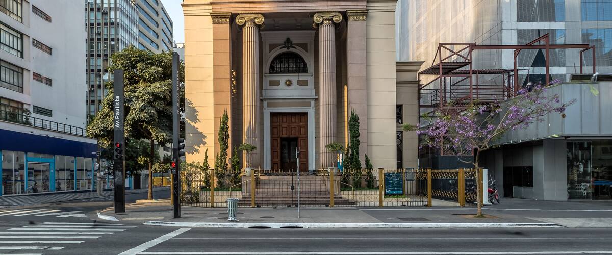 A neoclassical church with a cross on top, columns, and a large arched entrance.