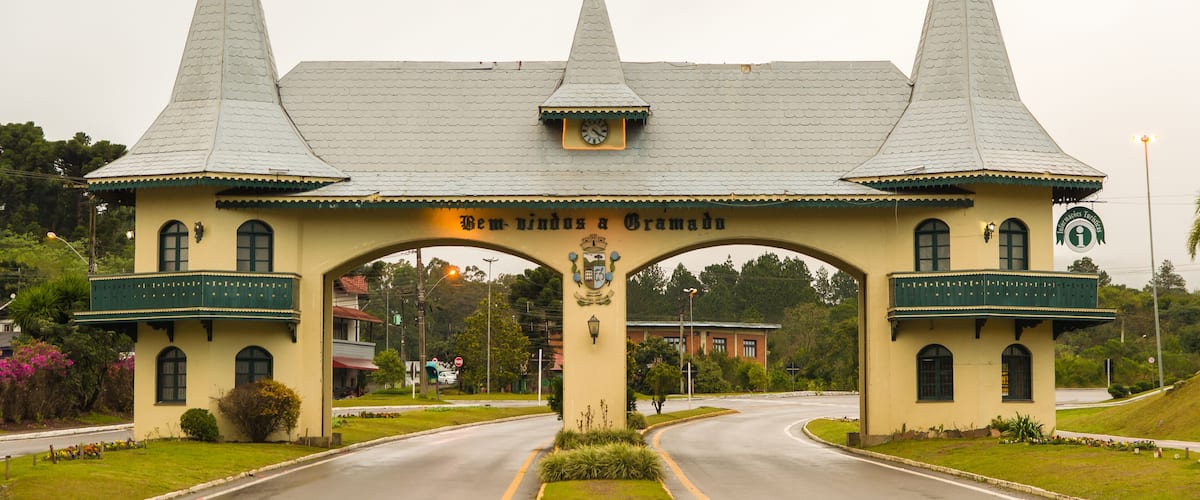 A historic building with a pointed roof and a central archway.