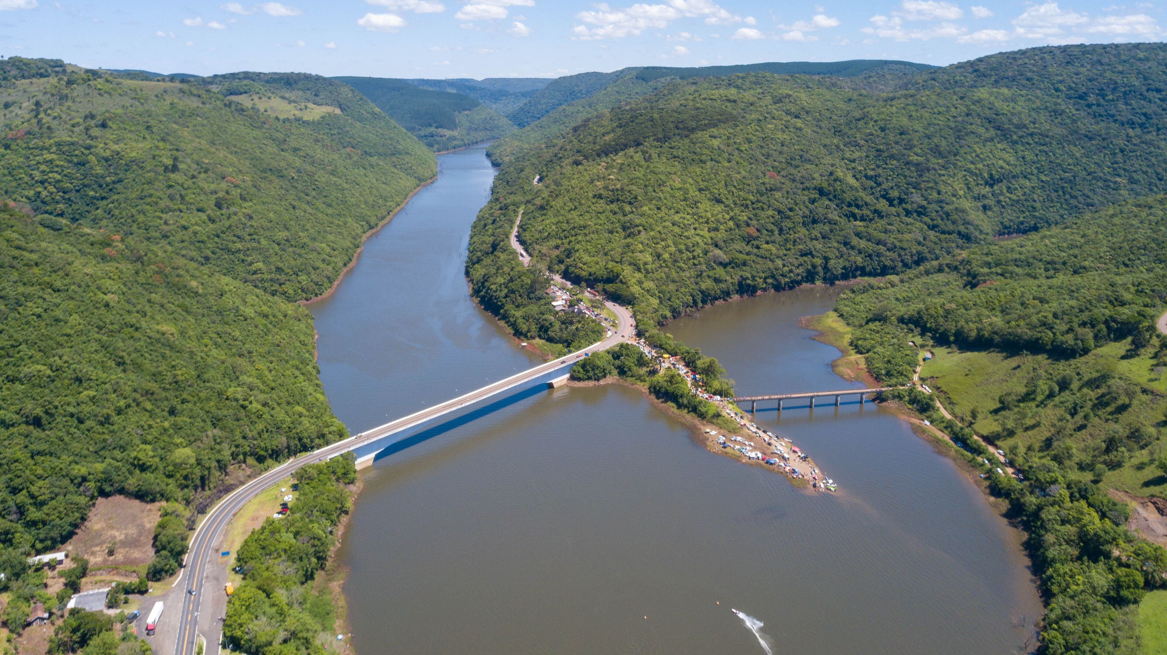 Aerial view of the Pelotas River bridge with its green mountains. Border between Rio Grande do Sul and Santa Catarina, Brazil