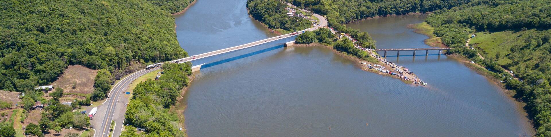 Aerial view of the Pelotas River bridge with its green mountains. Border between Rio Grande do Sul and Santa Catarina, Brazil