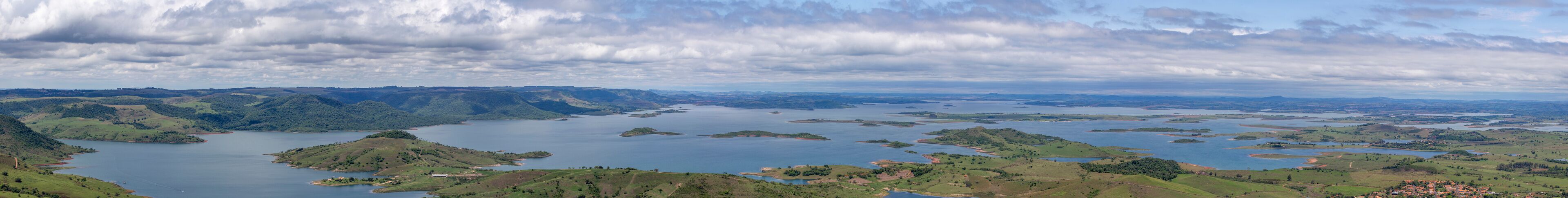 A vast lake surrounded by rolling hills and scattered islands.