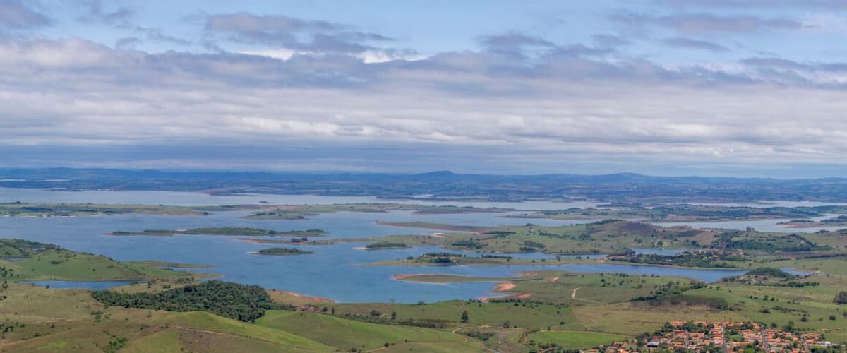 A vast lake surrounded by rolling hills and scattered islands.