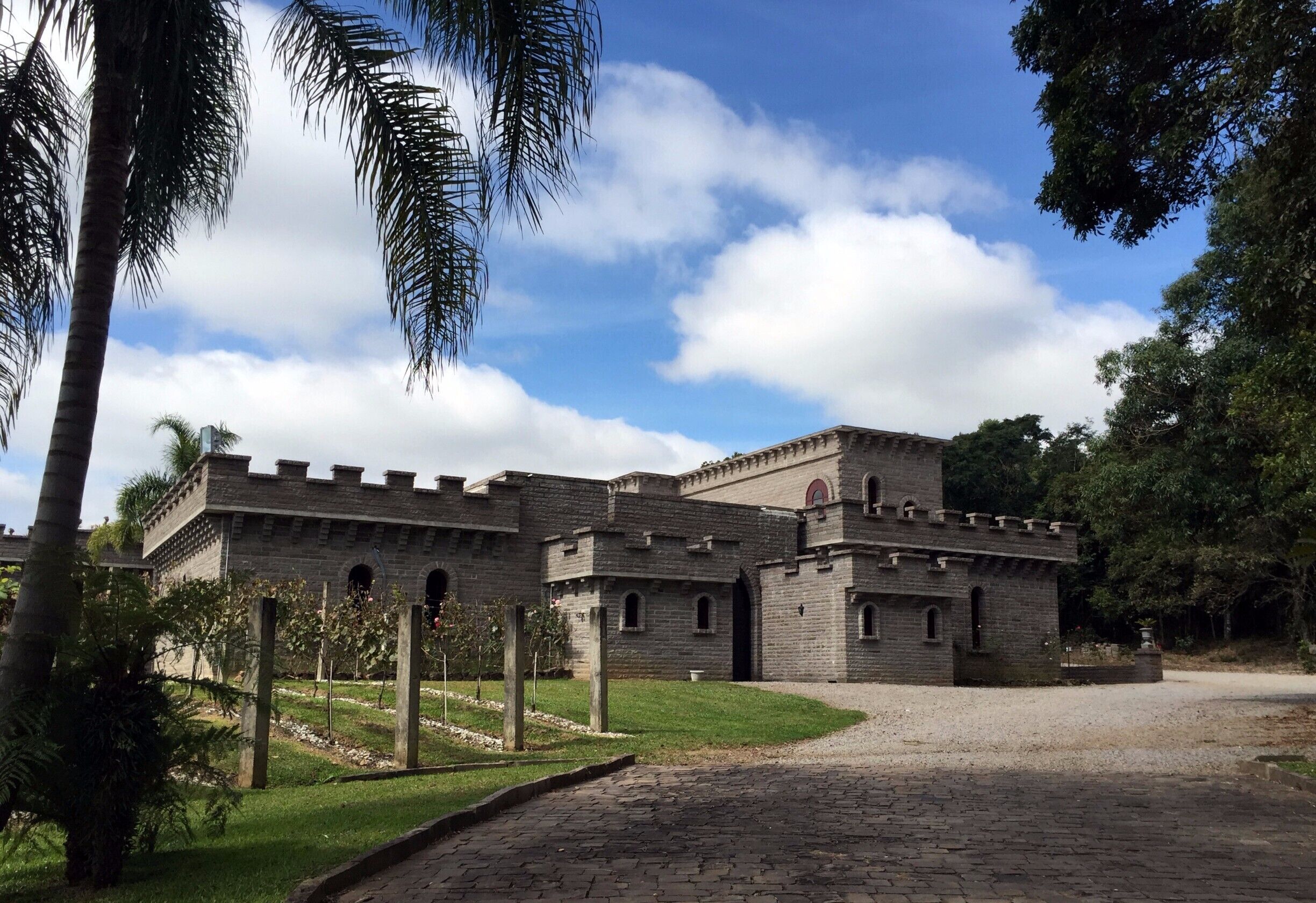 A medieval-style castle with a stone facade, arched windows, and battlements.