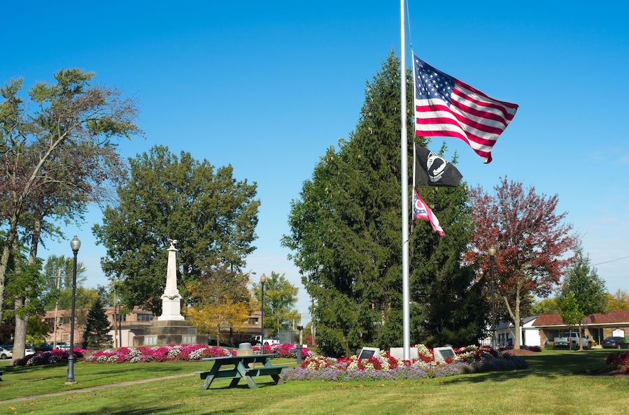 A U.S. flag flies at half staff in the midst of the town square in Twinsburg, Ohio