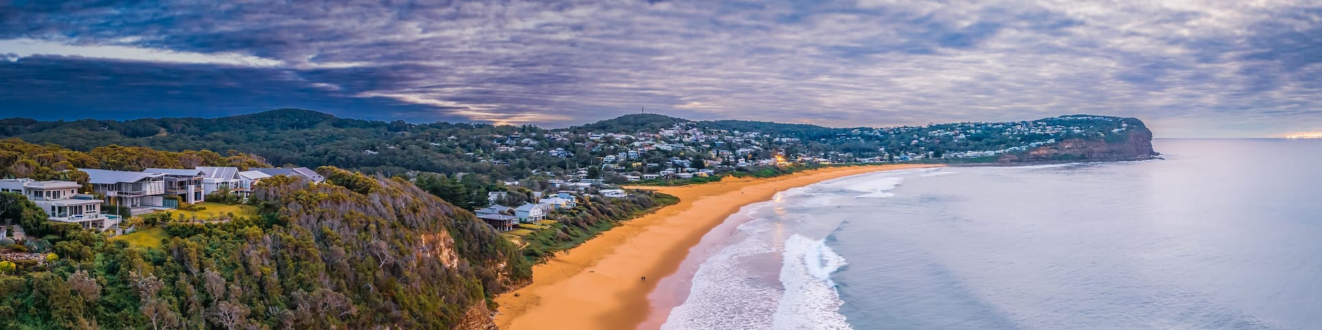 Cloud filled sunrise panorama over the beachside suburb
