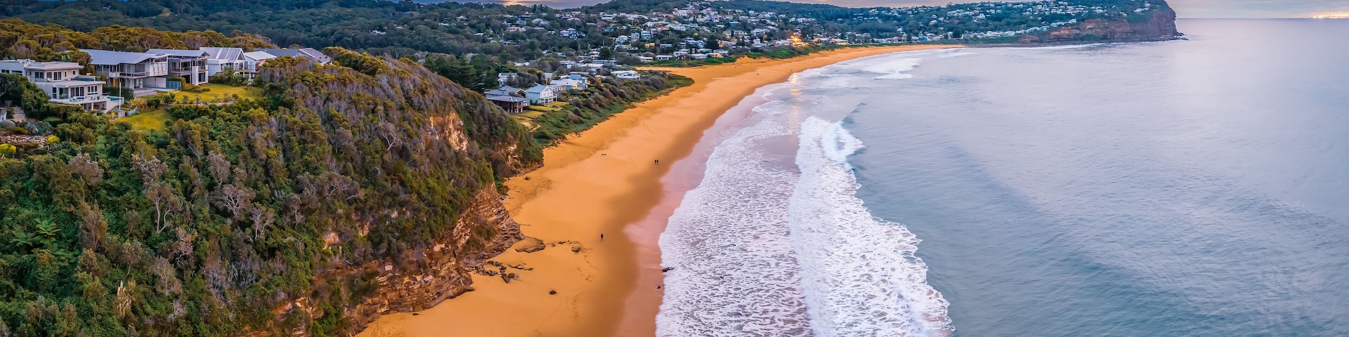 Cloud filled sunrise panorama over the beachside suburb