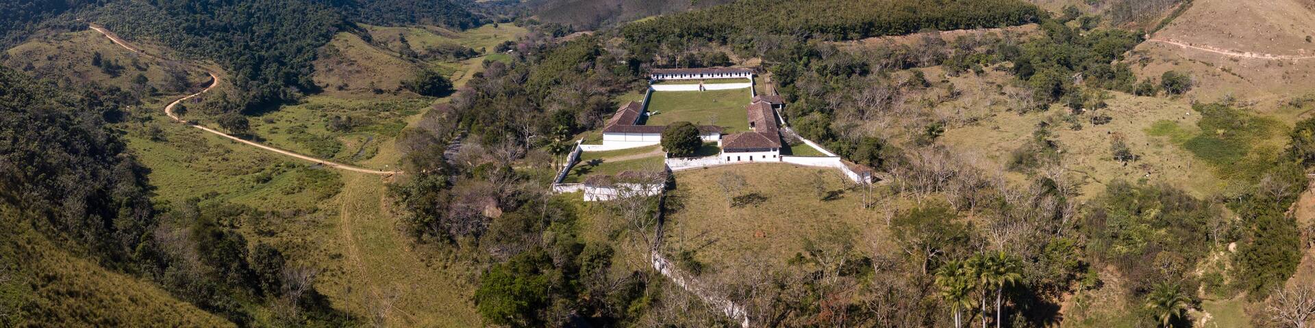 Beautiful drone aerial view of historical coffee farm and landscape of mountains in Serra da Bocaina in sunny summer day. São Paulo, Brazil. Concept of travel, tourism, nature, history, architecture.
