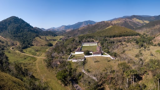 Beautiful drone aerial view of historical coffee farm and landscape of mountains in Serra da Bocaina in sunny summer day. São Paulo, Brazil. Concept of travel, tourism, nature, history, architecture.