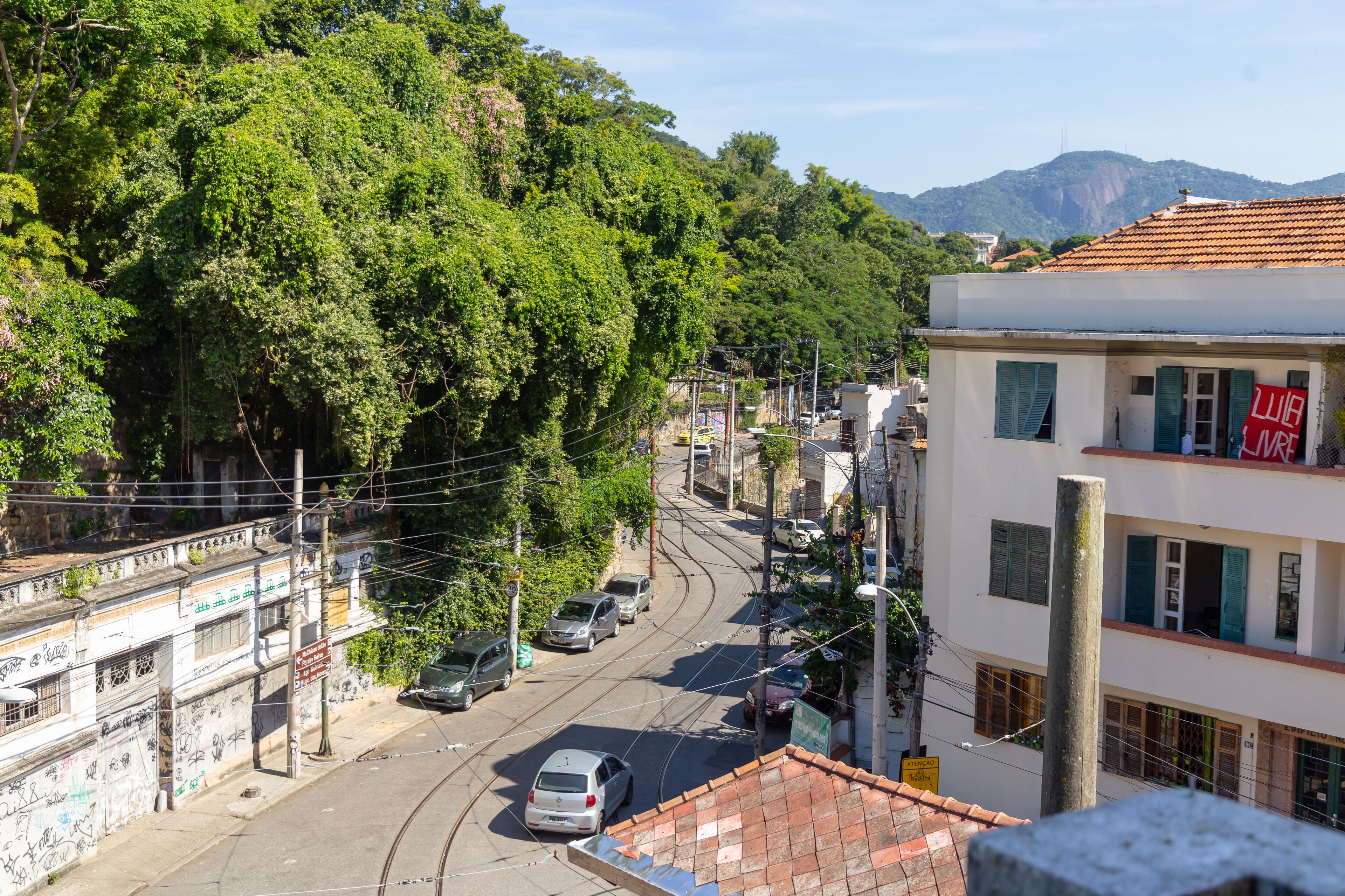 A street with cars, buildings, and trees.