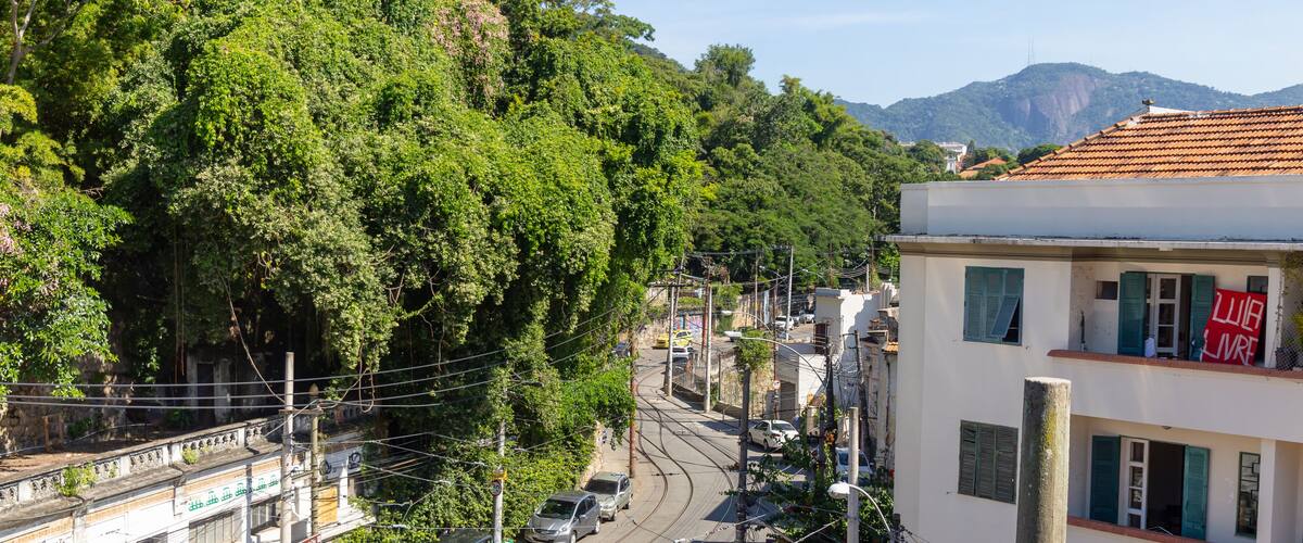 A street with cars, buildings, and trees.