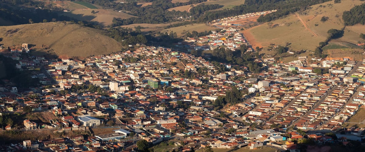A densely populated town nestled in a valley with surrounding hills and sparse vegetation.