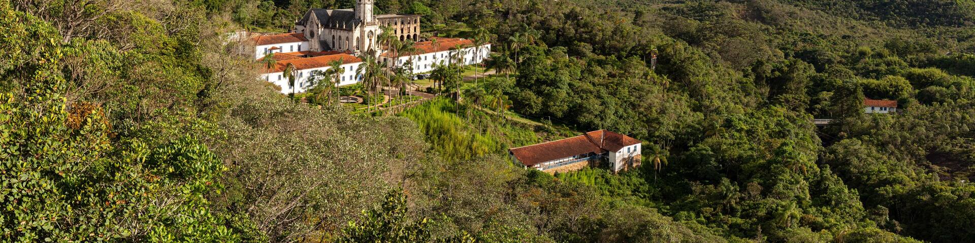 Panoramic aerial view of Sanctuary Caraça with mountains and blue sky in background, Minas Gerais, Brazil