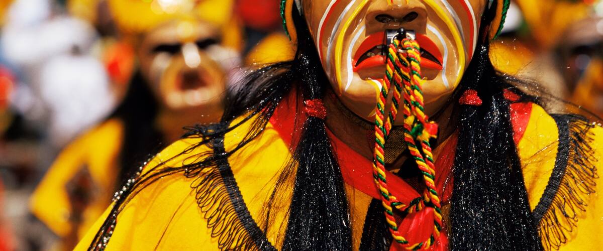 A person wearing a yellow and black costume with a headpiece.