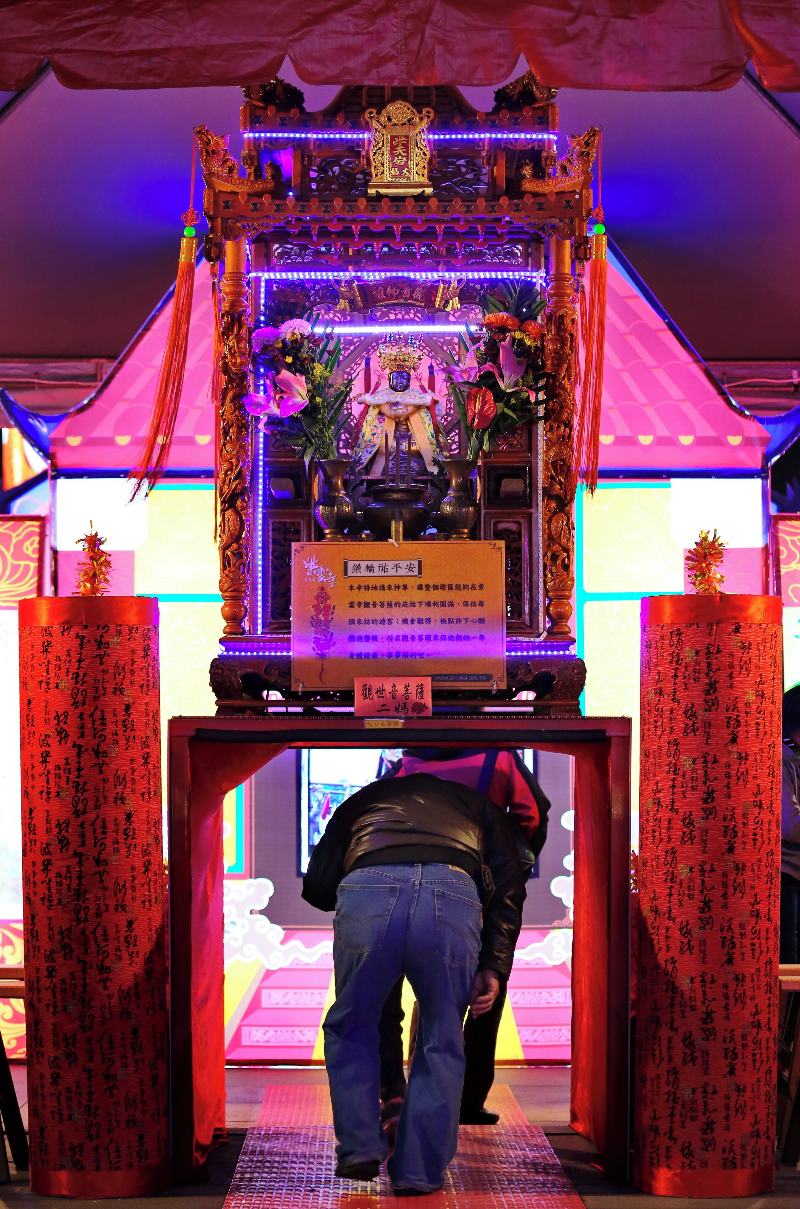 Worshipers crawling beneath the divine palanquin at the Chiayi Lantern Festival, Taiwan.