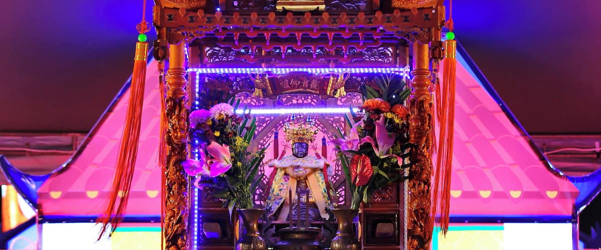 Worshipers crawling beneath the divine palanquin at the Chiayi Lantern Festival, Taiwan.