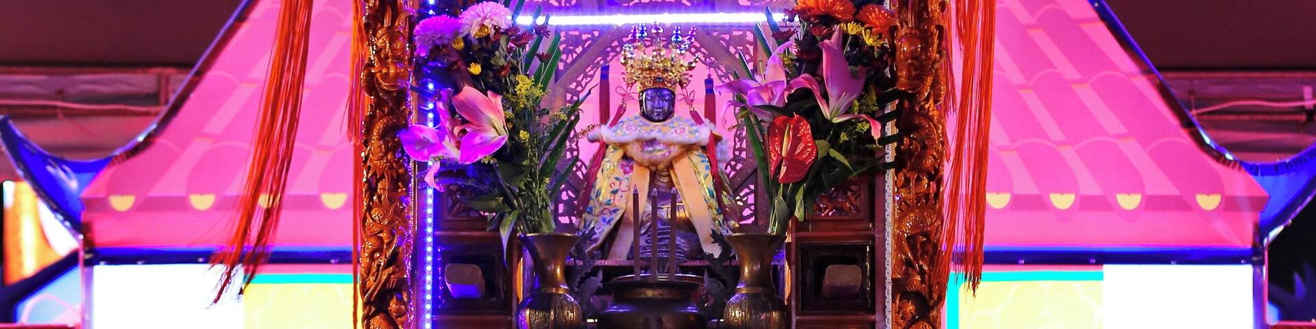 Worshipers crawling beneath the divine palanquin at the Chiayi Lantern Festival, Taiwan.