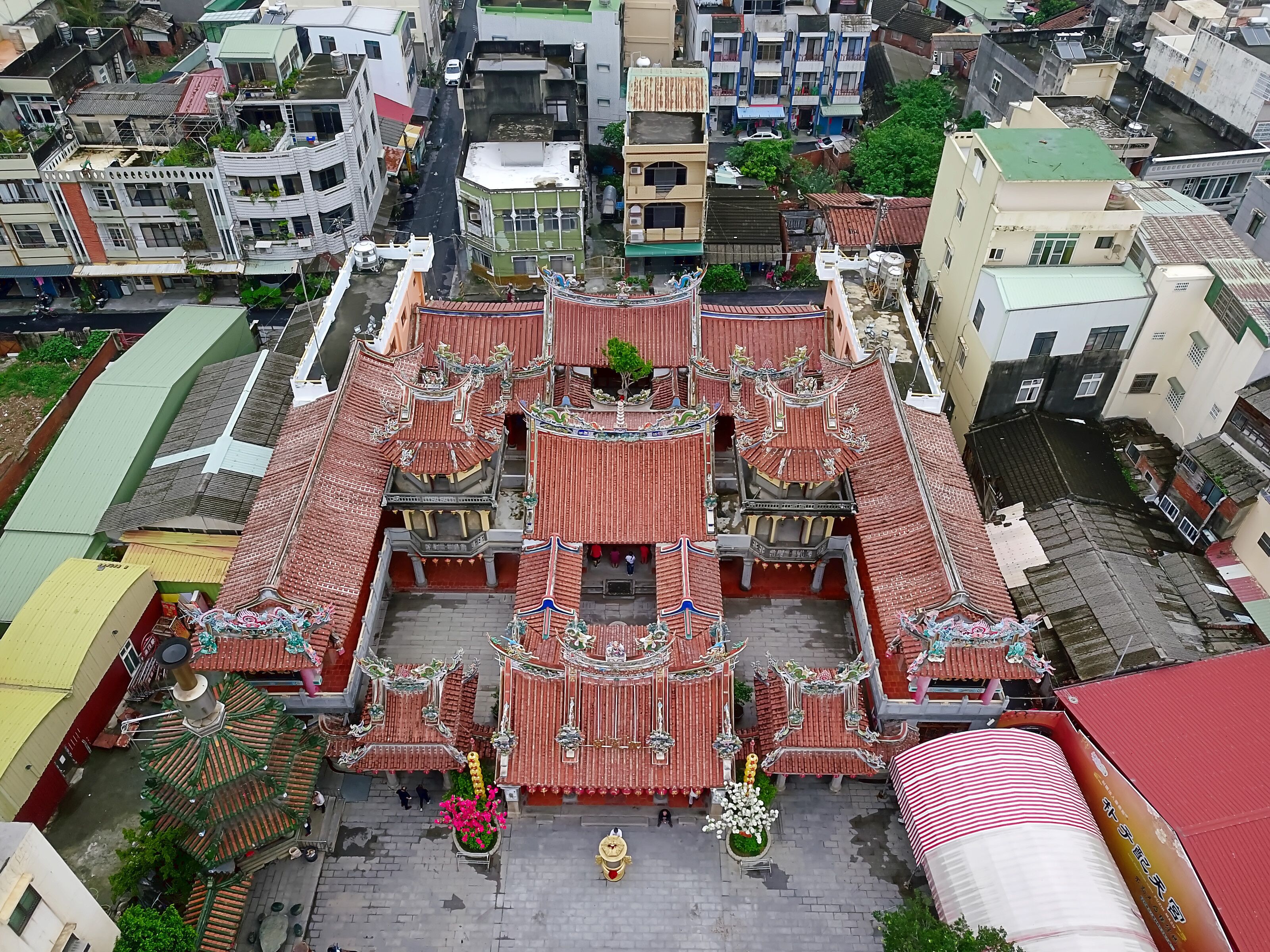 An aerial view of a traditional temple complex with ornate roofs and a central courtyard.