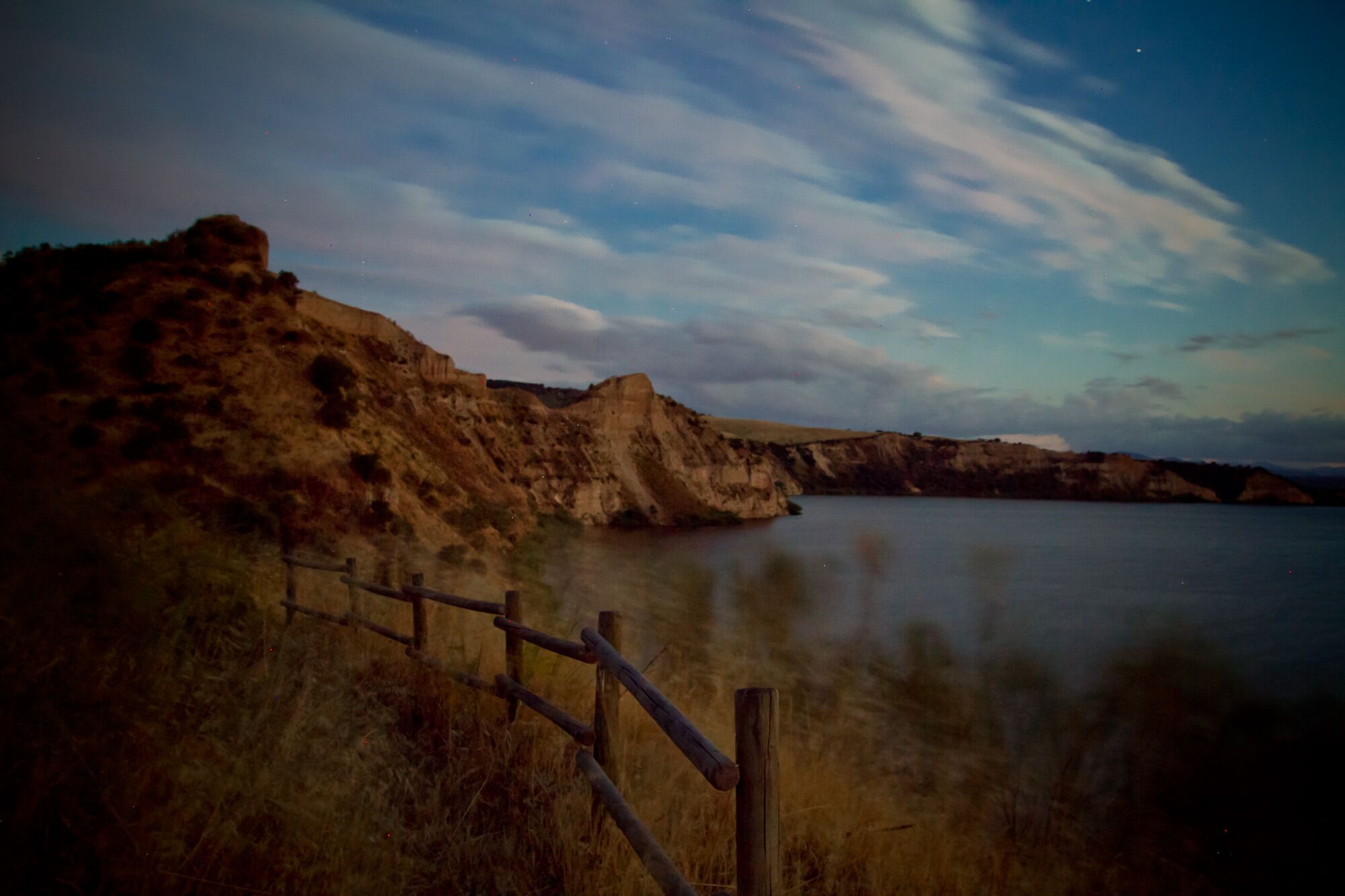 A coastal landscape with cliffs and a calm body of water.