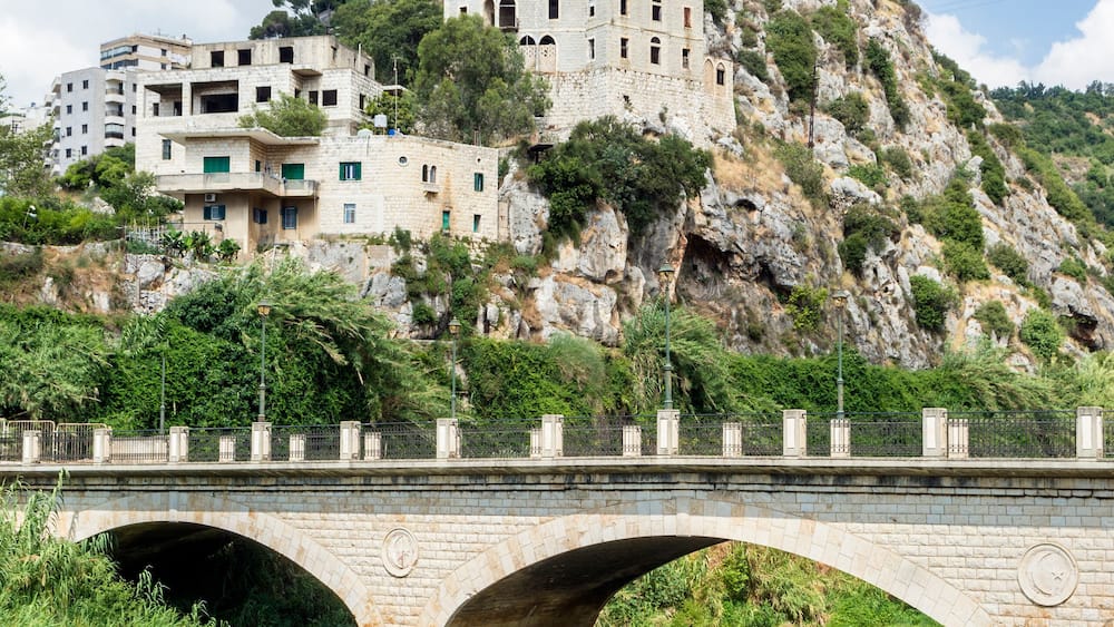 Historic bridge in Nahr el Kalb valley and Christ King statue, Zouk Mosbeh, Lebanon