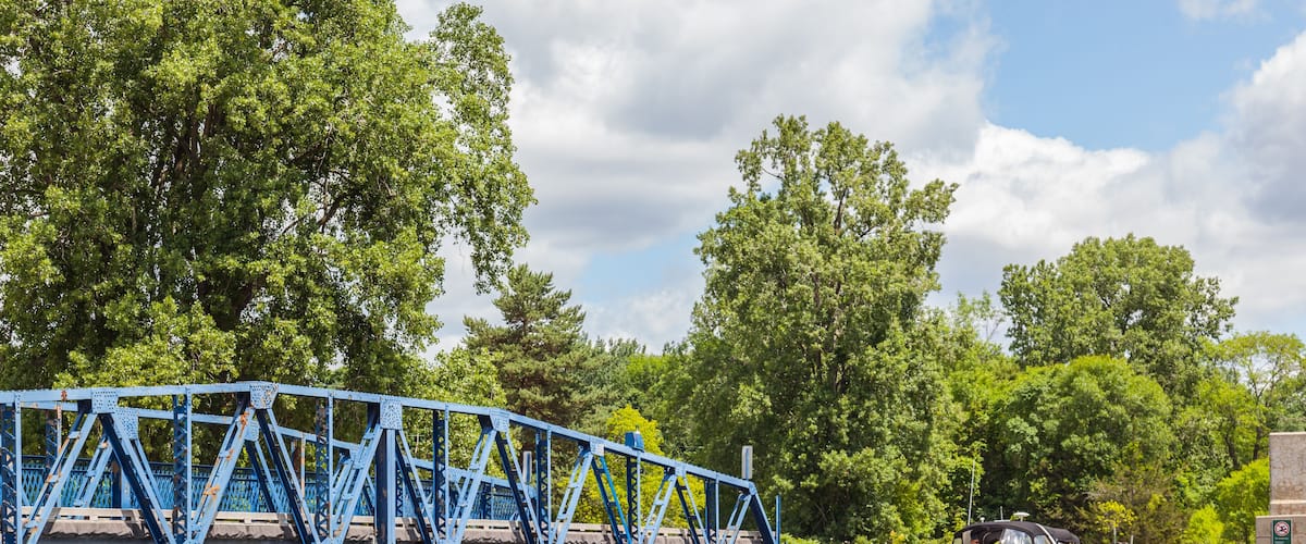 QUINTE WEST, ONTARIO, CANADA - July 10, 2016: Boat passing opened swing bridge on Murray Canal, Quinte West, Ontario.
The Murray Canal was built between 1882 and 1889.