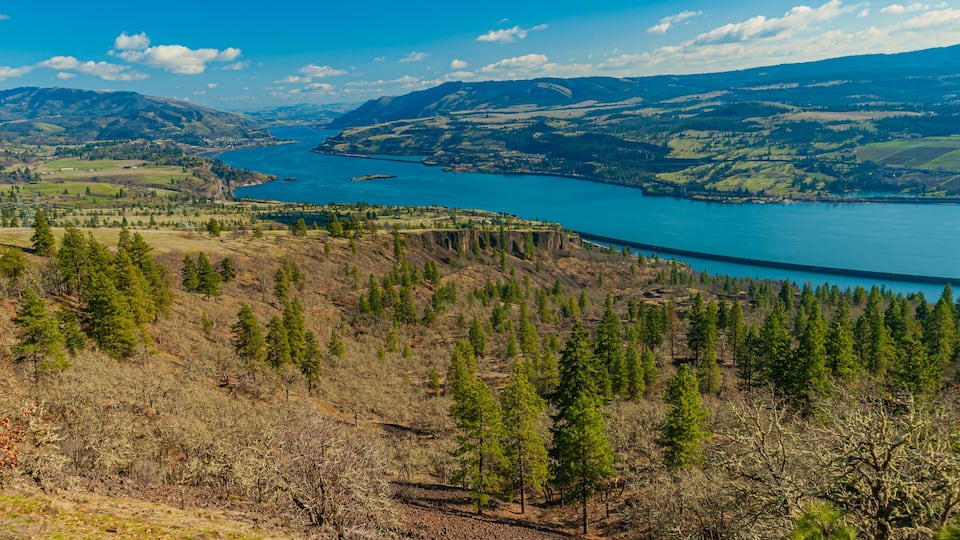A lake surrounded by hills and trees.