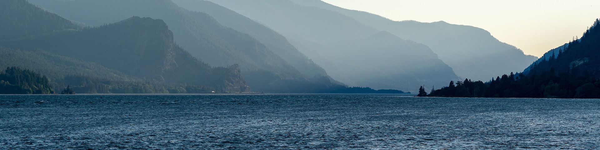 Mountain range illuminated in layers by the slanting rays of the western evening sun in the Columbia River Gorge