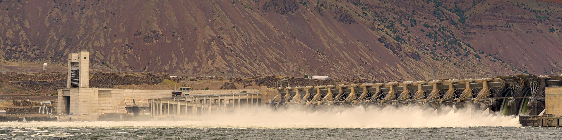 John Day Dam on the columbia River, showing the spillways, fish ladder and navigation locks, Rufus Oregon. Focus stacked to insure sharp focus. Wind turbine generators on ridge line.