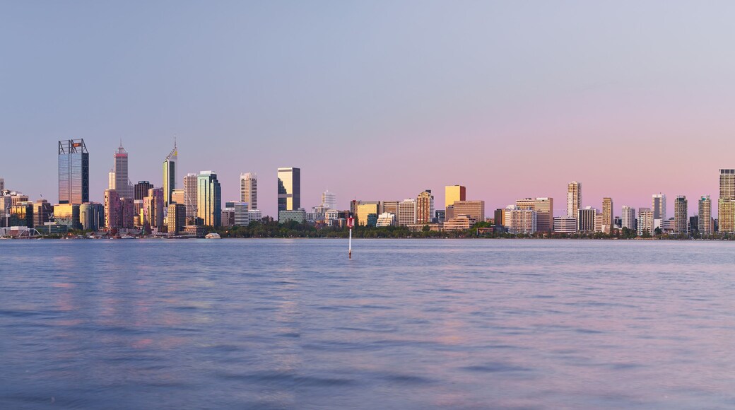 Panoramic view of the Perth skyline across the Swan River at dusk.