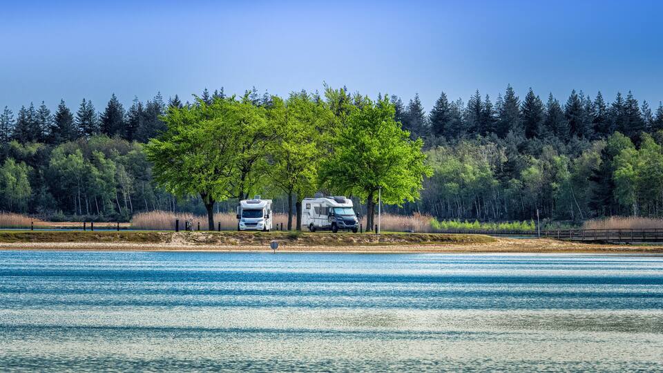 Camper vans parked near lake in Eersel, Netherlands