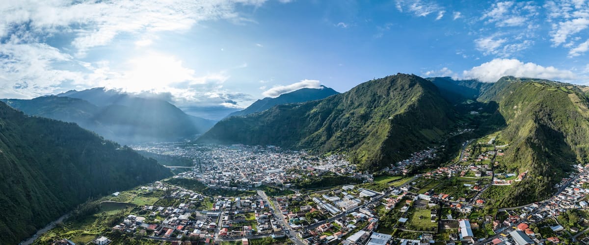 A valley with a town nestled between mountains.