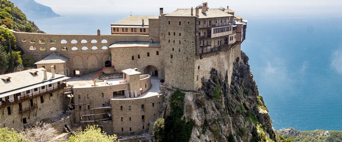A historic stone fortress perched on a cliff overlooking the sea.
