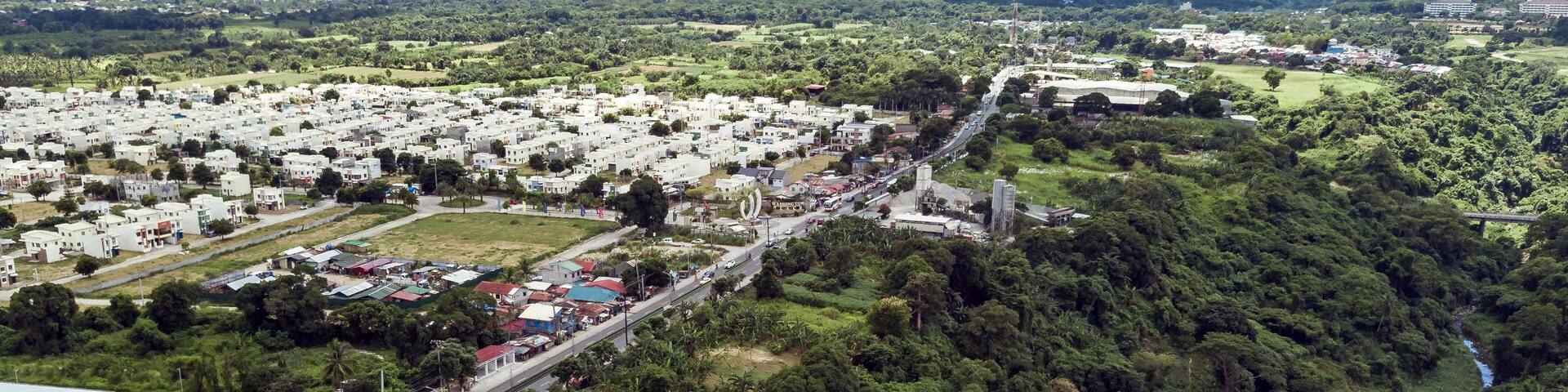 Aerial of Emilio Aguinaldo Highway and a nearby river in Dasmarinas Cavite. View of road that goes straight to Tagaytay