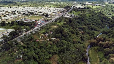 Aerial of Emilio Aguinaldo Highway and a nearby river in Dasmarinas Cavite. View of road that goes straight to Tagaytay