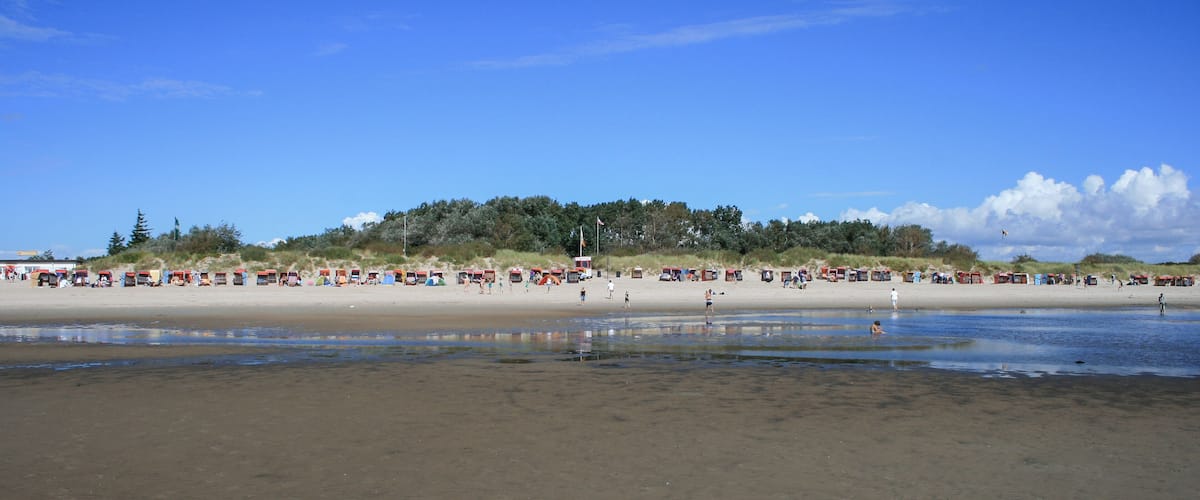 A beach with tents and people.