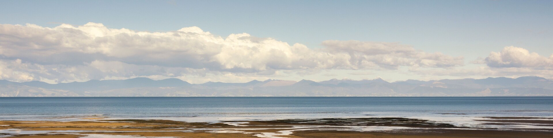 Panorama view on Tasman Bay near Marahau, South Island, New Zealand near the entrance of Abel Tasman National Park. A wonderful area for relaxing, hiking, kayaking and enjoying beautiful nature.