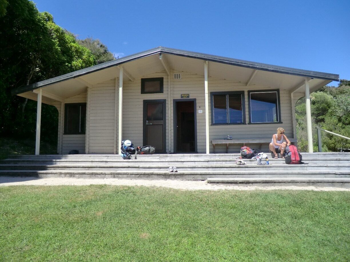 The Abel Tasman Coast Track is a 51km (32 mile) long New Zealand walking track within the Abel Tasman National Park. It extends from Marahau in the south to Wainui in the north, with many optional side tracks. You can rent a bed in a bunk bij the informationcentre in Picton. 
I recommend it if you want to make a nice hike. 