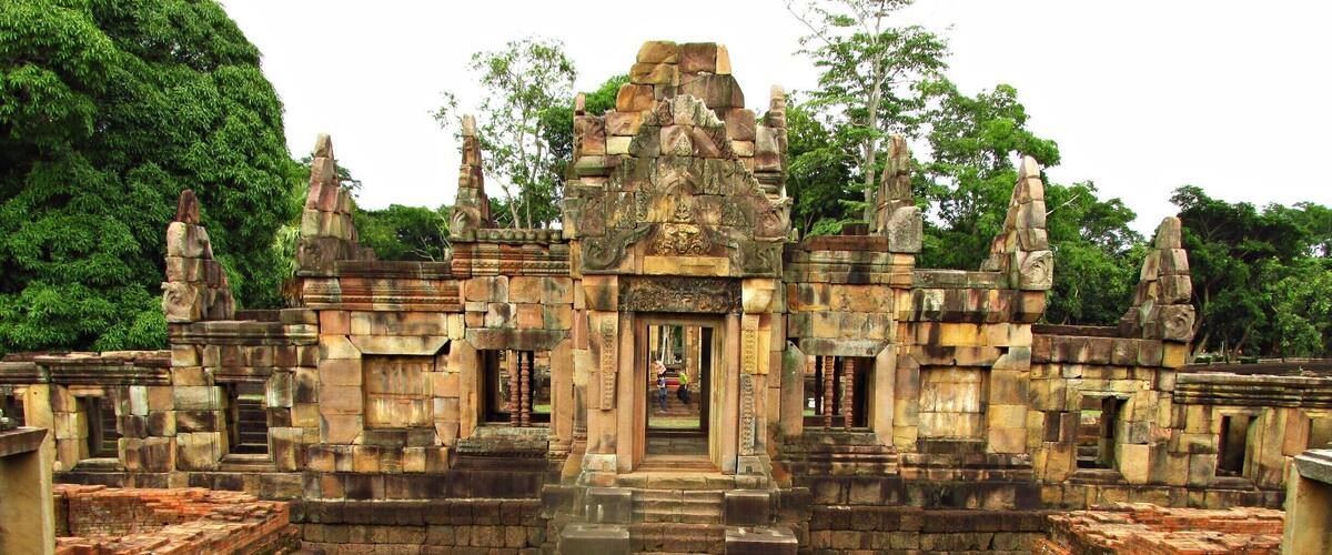 An ancient temple complex with intricate stone carvings and a central doorway.