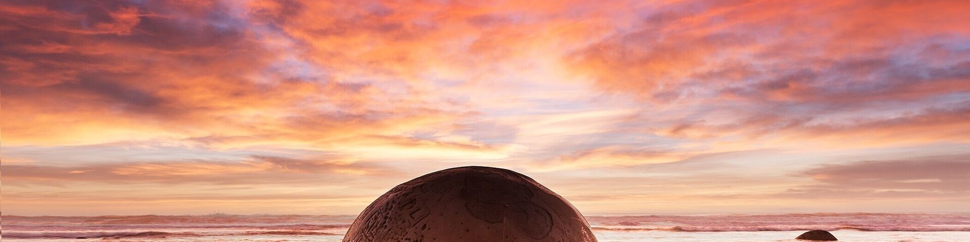 Moeraki Boulders in New Zealand. I've read there are times that are better to visit than the other depending on the tide but I have also seen these massive eggs covered with water and the tops only sticking out at the photo was incredible!!! A must visit for any sunset and tide!!