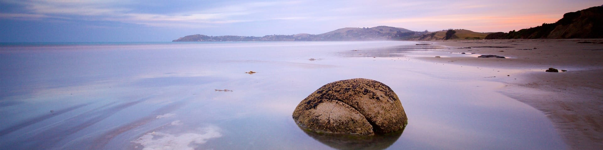 Hampden showing a sunset and a lake or waterhole
