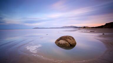 Hampden showing a sunset and a lake or waterhole
