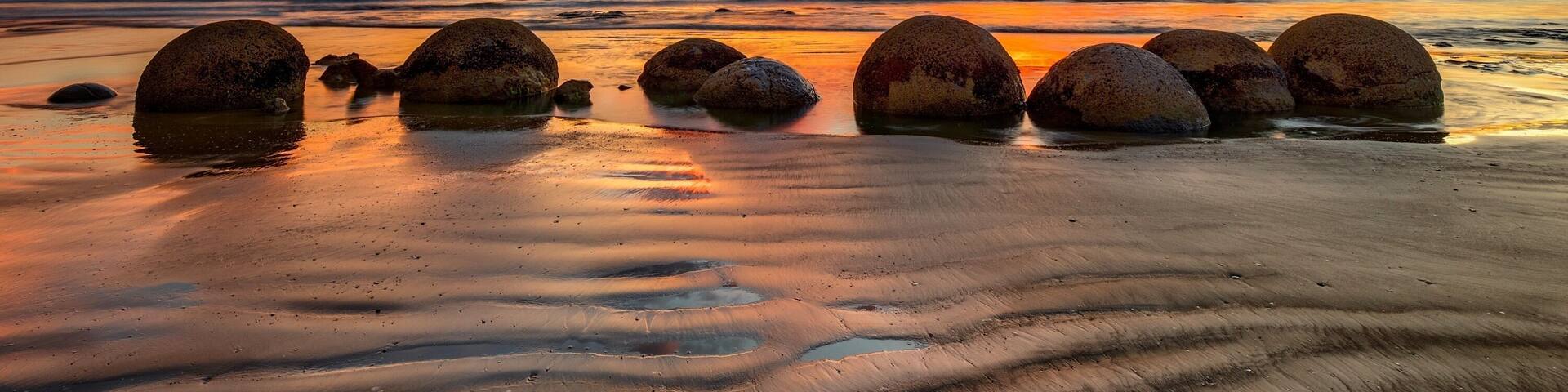 The amazing Moeraki Boulders. These perfectly spherical boulders emerge from the sand cliffs with erosion and roll down onto the beach. Made naturally over thousands of years under the ground they are a great subject to photograph at sunrise on the beach as the sun rises over the eastern horizon. Get there early as you’ll find many turn up to get the best spot and there are limited stones!