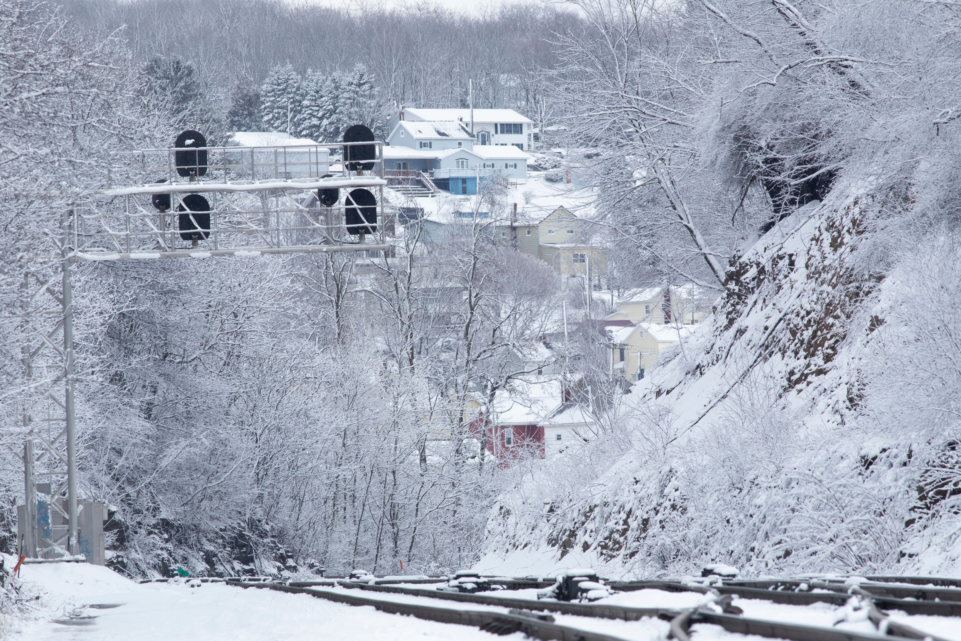 Snowy landscape with train tracks and signal