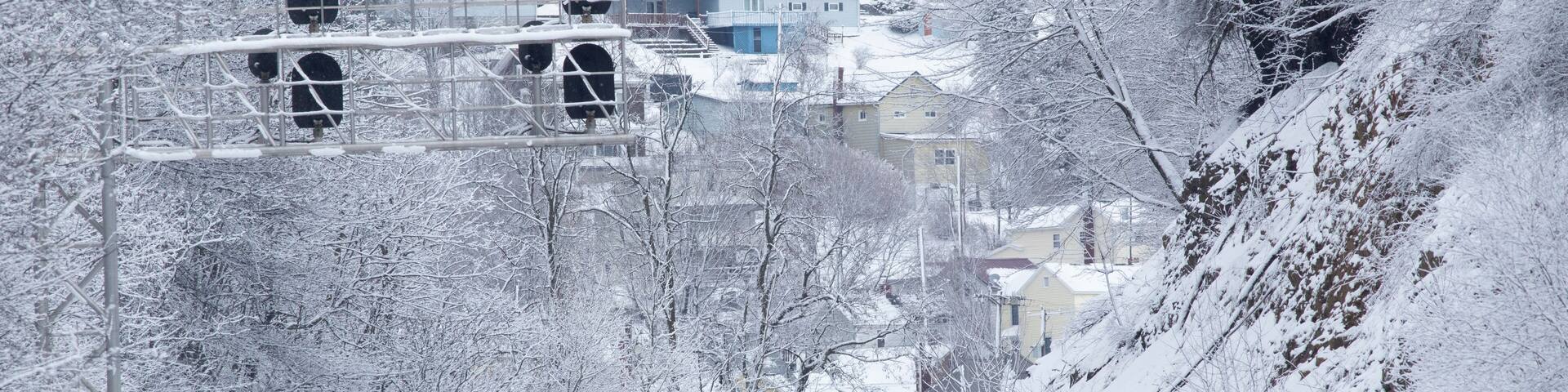 Snowy landscape with train tracks and signal