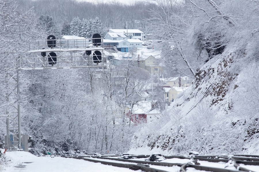 Snowy landscape with train tracks and signal