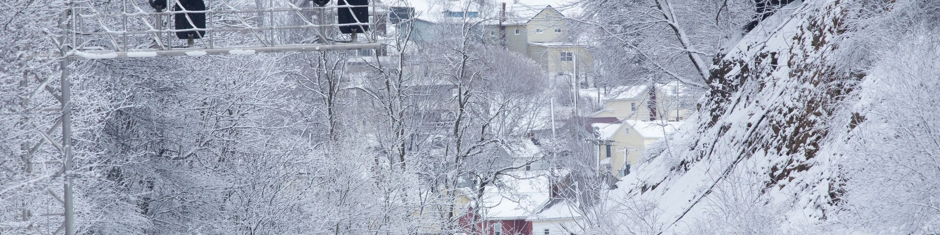 Snowy landscape with train tracks and signal